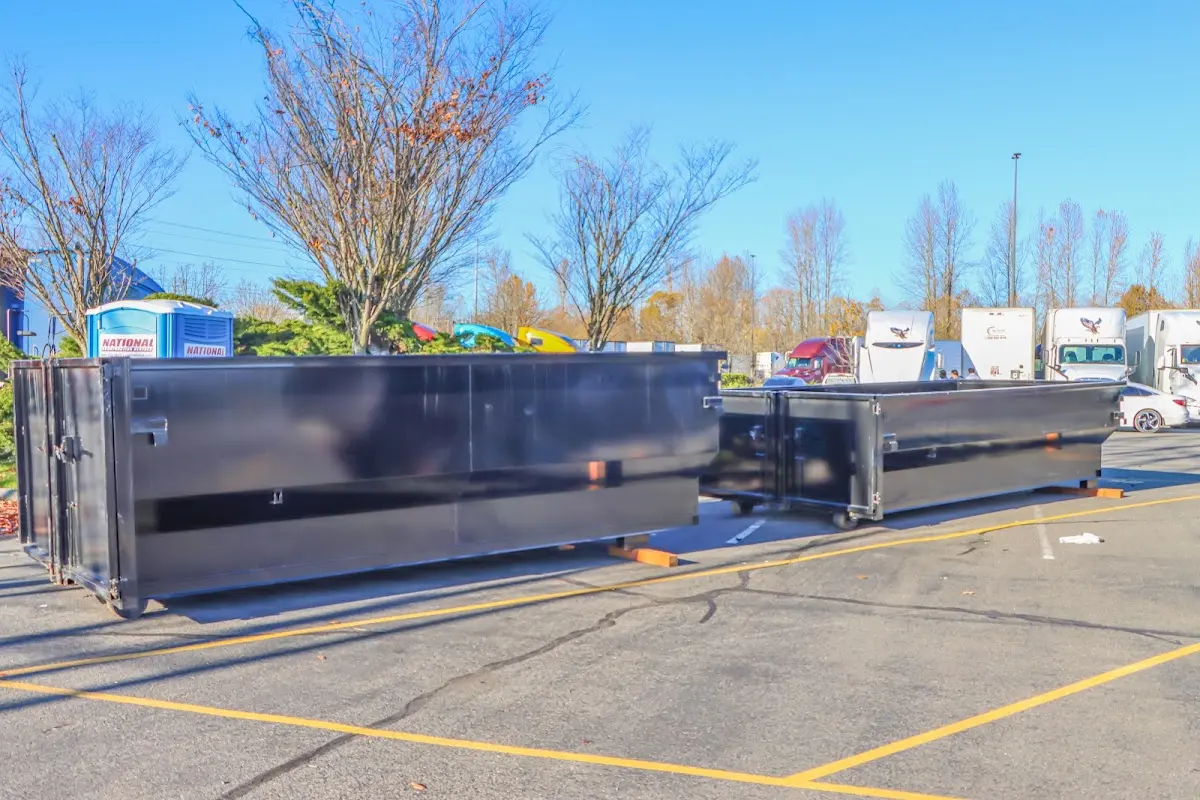 Professional dumpster rental service with roll-off container on residential driveway in Shamong